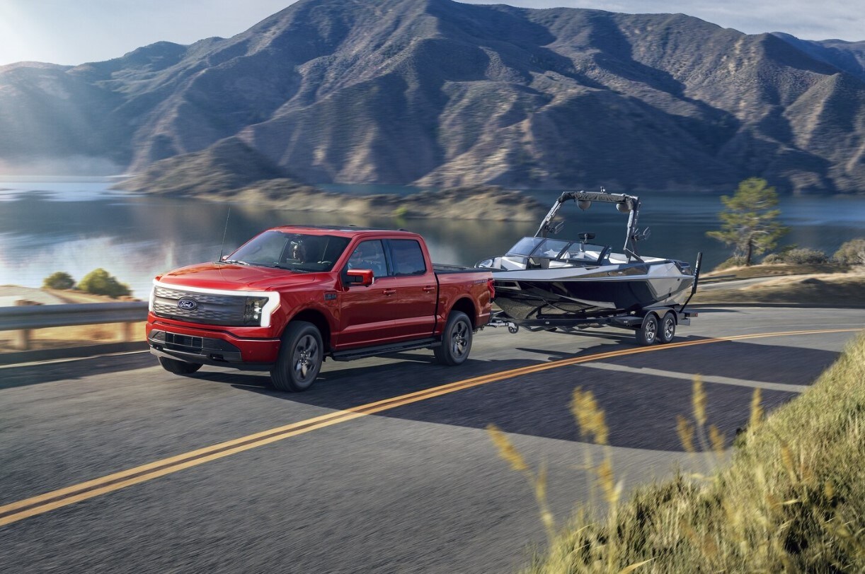 Lightning%20Tow%20%202024-07-03%20092558.jpg A Ford F-150 Lightning pulling a boat down a mountain road.