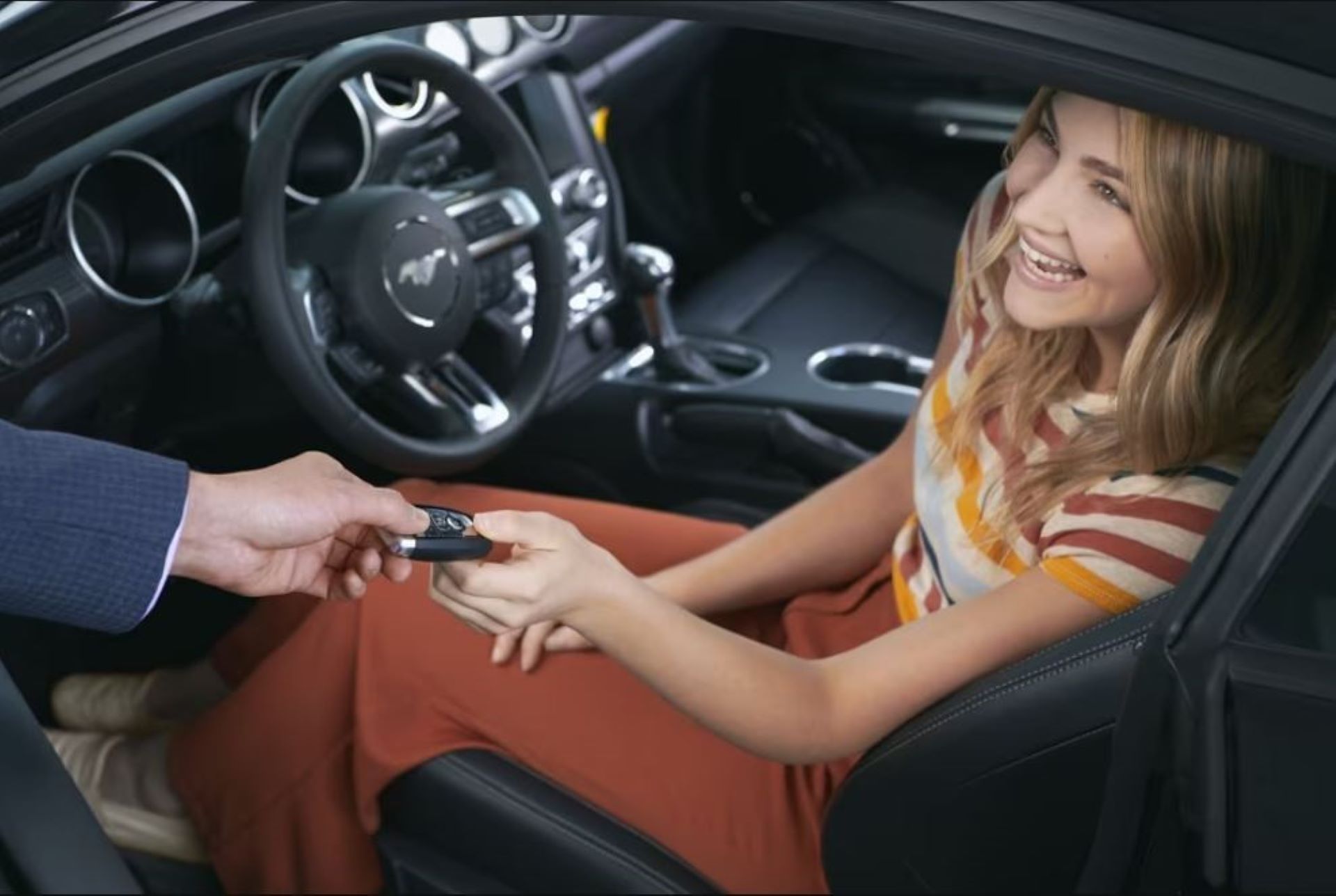 Ford PLFM.JPG A woman taking the keys for a CPO Ford Mustang.