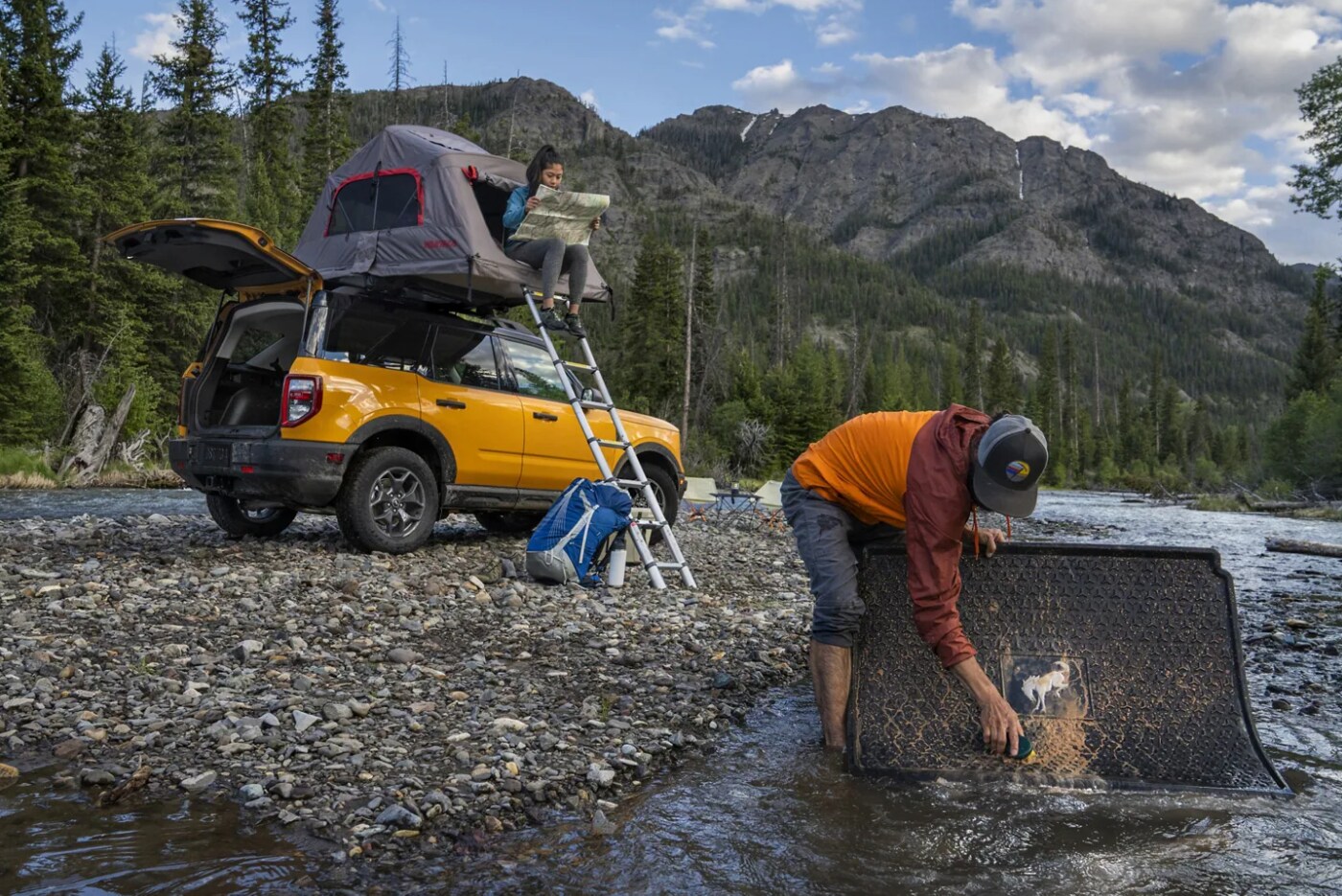 2023-bronco-sport-badland-3.PNG A yellow 2023 Ford Bronco Sport Badlands Edition sits parked at a campsite next to a creek