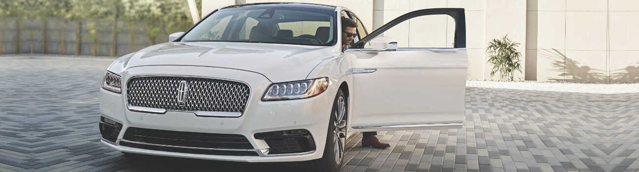 New 2019 Lincoln Continental in Colorado Springs at Phil Long Lincoln.png Front angle of a white 2019 Lincoln Continental with the driver side door open as the driver gets out of the new Lincoln car parked in his driveway