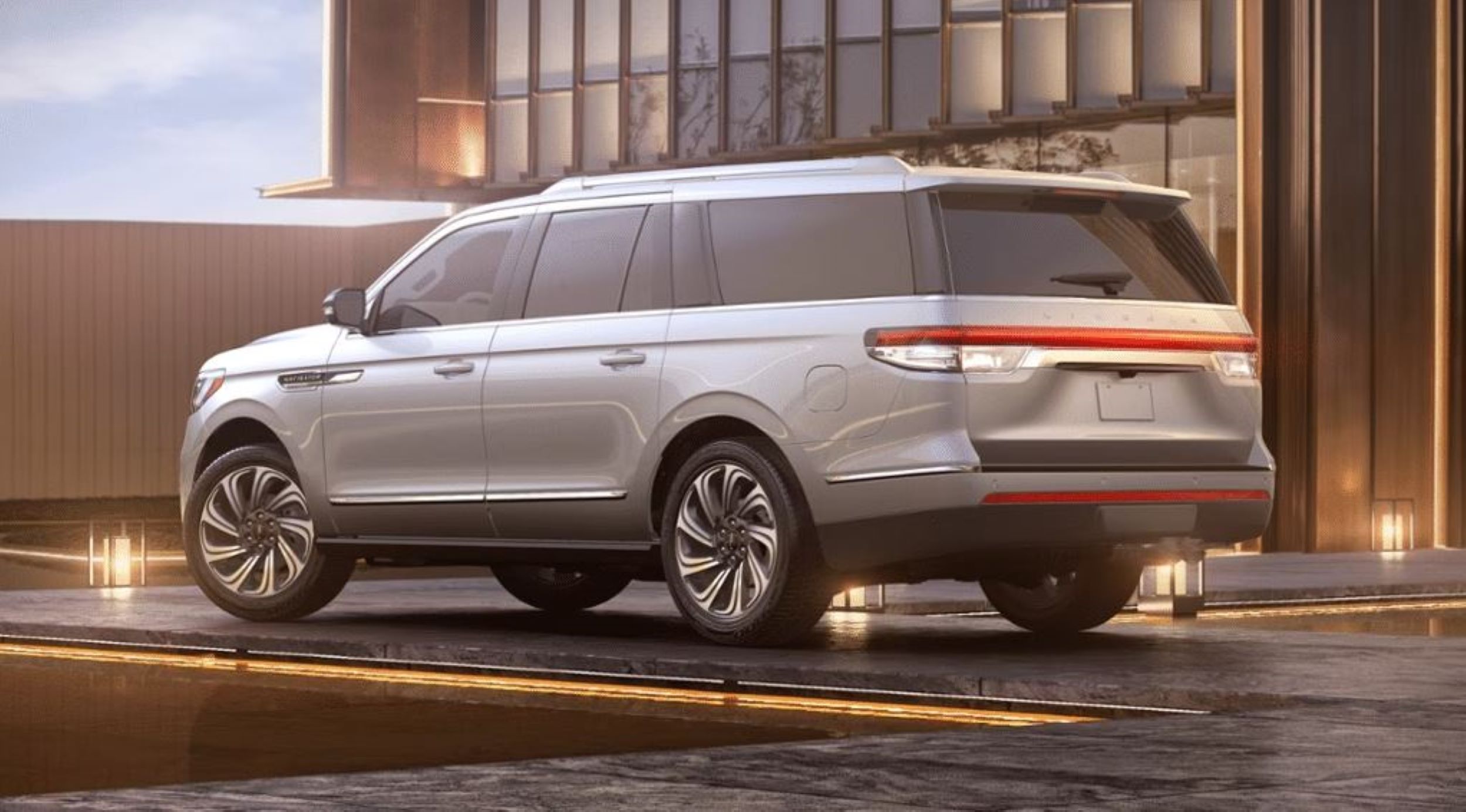 1 Lincoln-Navigator-2024.JPG A Lincoln parked in front of a luxurious modern home.
