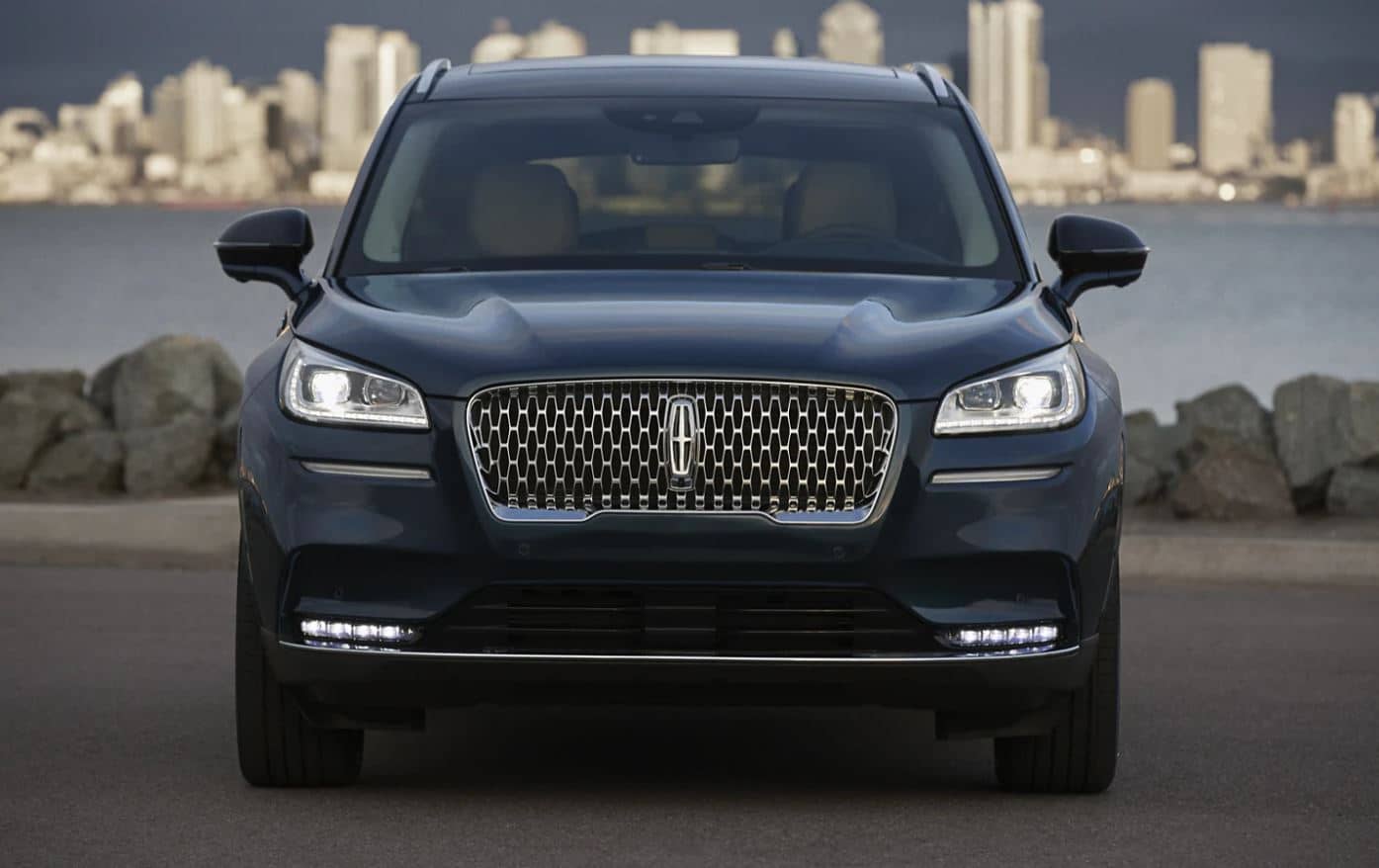 2022 Lincoln Corsair Exterior Dark blue 2022 Lincoln Corsair SUV parked with a lake in the background and tall buildings on the other side