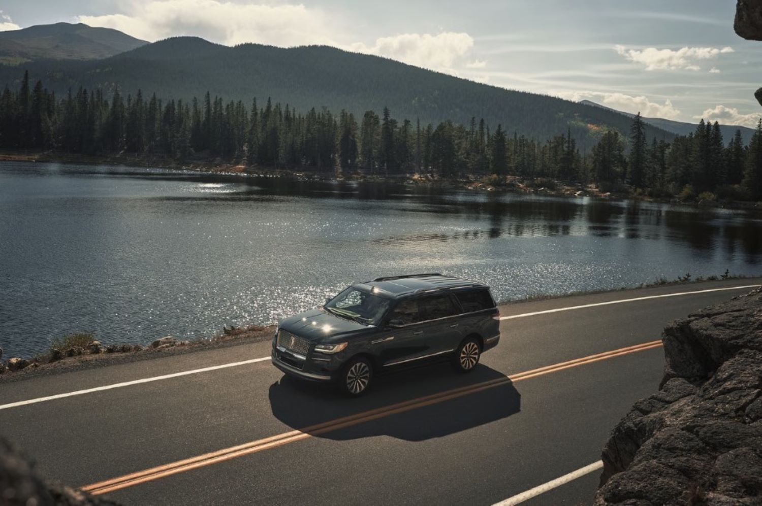 Lincoln%20Navigator.jpg A Lincoln driving next to a mountain lake.