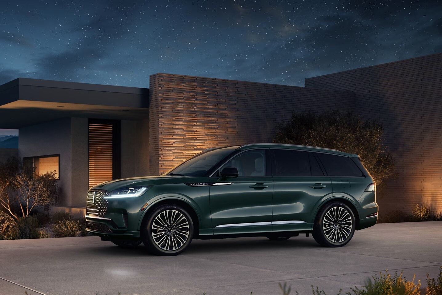 Screenshot%202024-12-26%20at%201.11.23%20PM.png A green Lincoln Aviator parked outside a home at night.