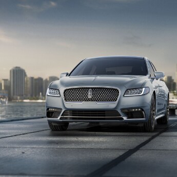 2019 Lincoln Continental at Phil Long Lincoln.png A view of the front of a dark silver 2019 Lincoln Continental parked at
the end of a concrete pier overlooking a bay of water with sailboats and a big
city on the distant horizon