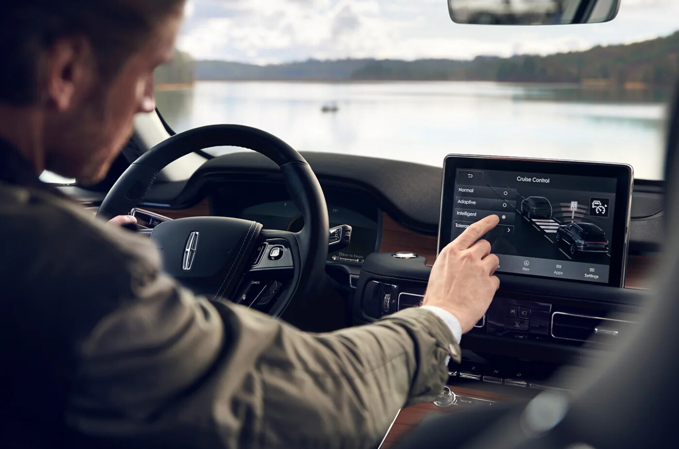 2022-Lincoln-Aviator-5.PNG A man uses the touchscreen interface mounted to the dash of the 2022 Lincoln Aviator Hybrid