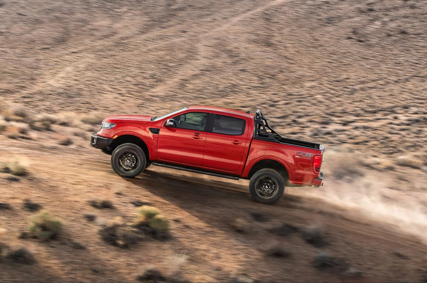 2023-Ford-Ranger-3.PNG A red 2023 Ford Ranger races up a dusty trail