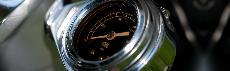 Schedule Ford Car Repair and Maintenance Service at Phil Long Ford in Raton NM.png A close view of a silver oil gauge under the hood of a car reading oil psi with a blurry background