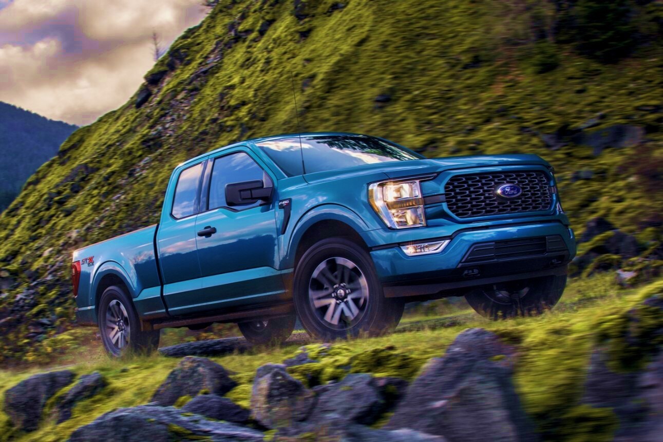 2021-ford-f150-14.jpg 2021 blue Ford F-150 driving up a mountain road