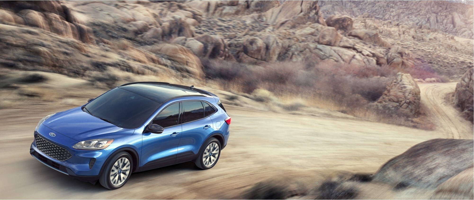 2020-ford-escape-driving-phil-long-ford-raton-ford-dealership-nm.jpg A blue Ford Escape driving in the desert