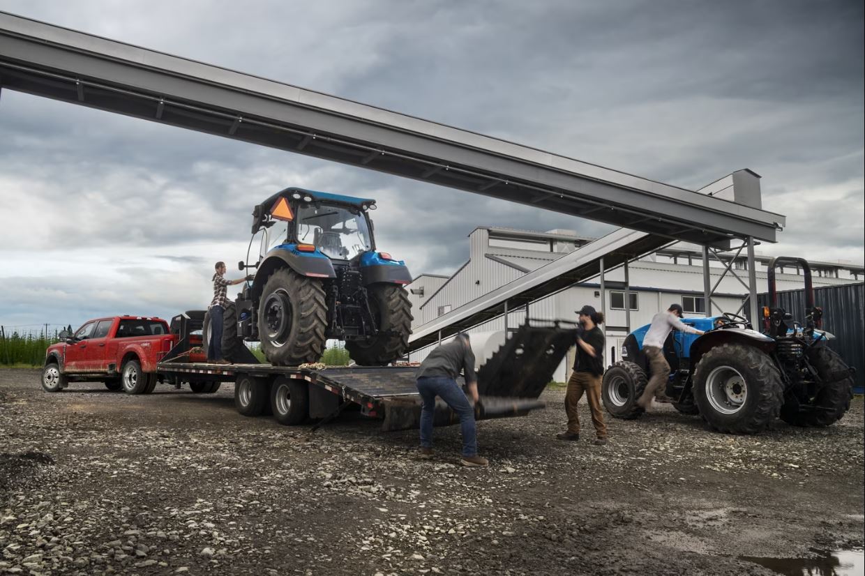 Super Duty Pulling Tractor.JPG A Ford F-350 parked outside a worksite pulling a large tractor.