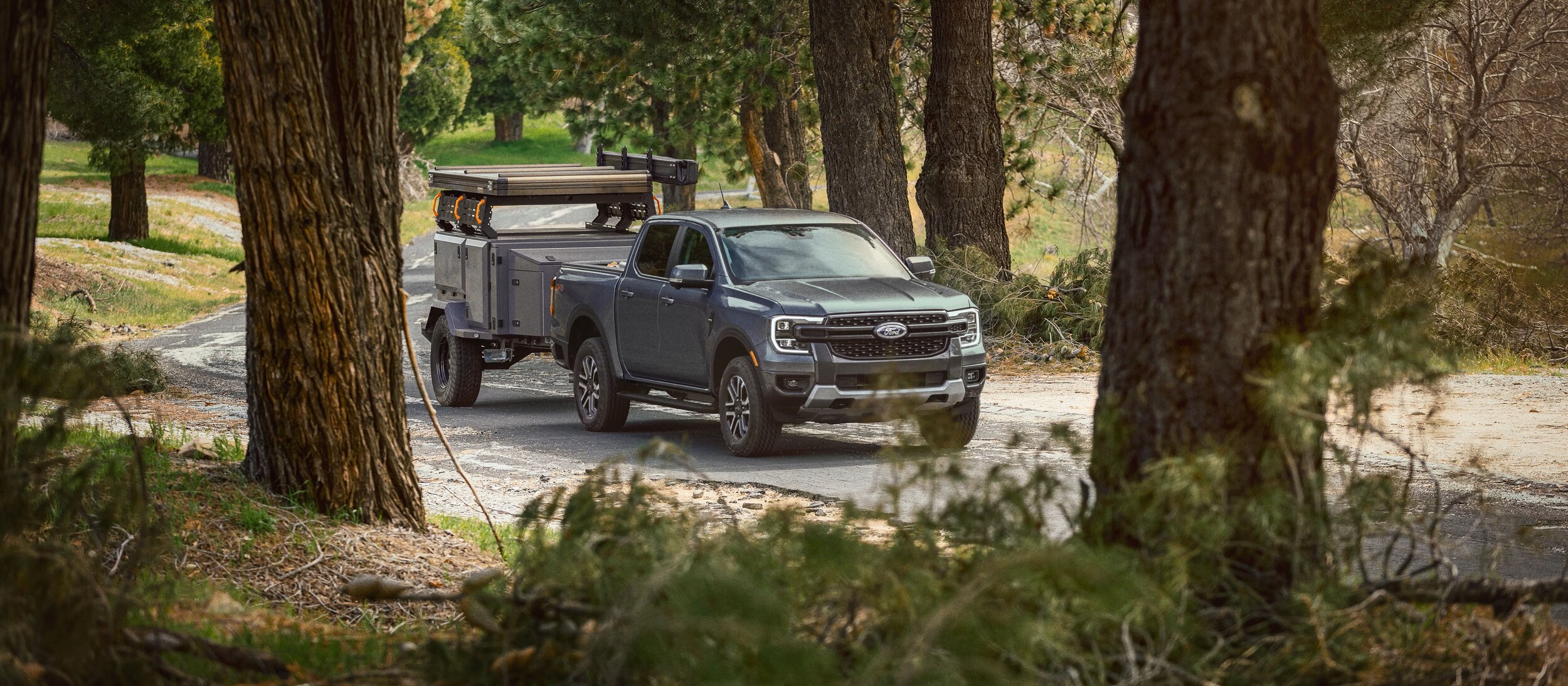 Screenshot%202025-03-18%20203819.png 2025 Ford Ranger towing a trailer in the forest.