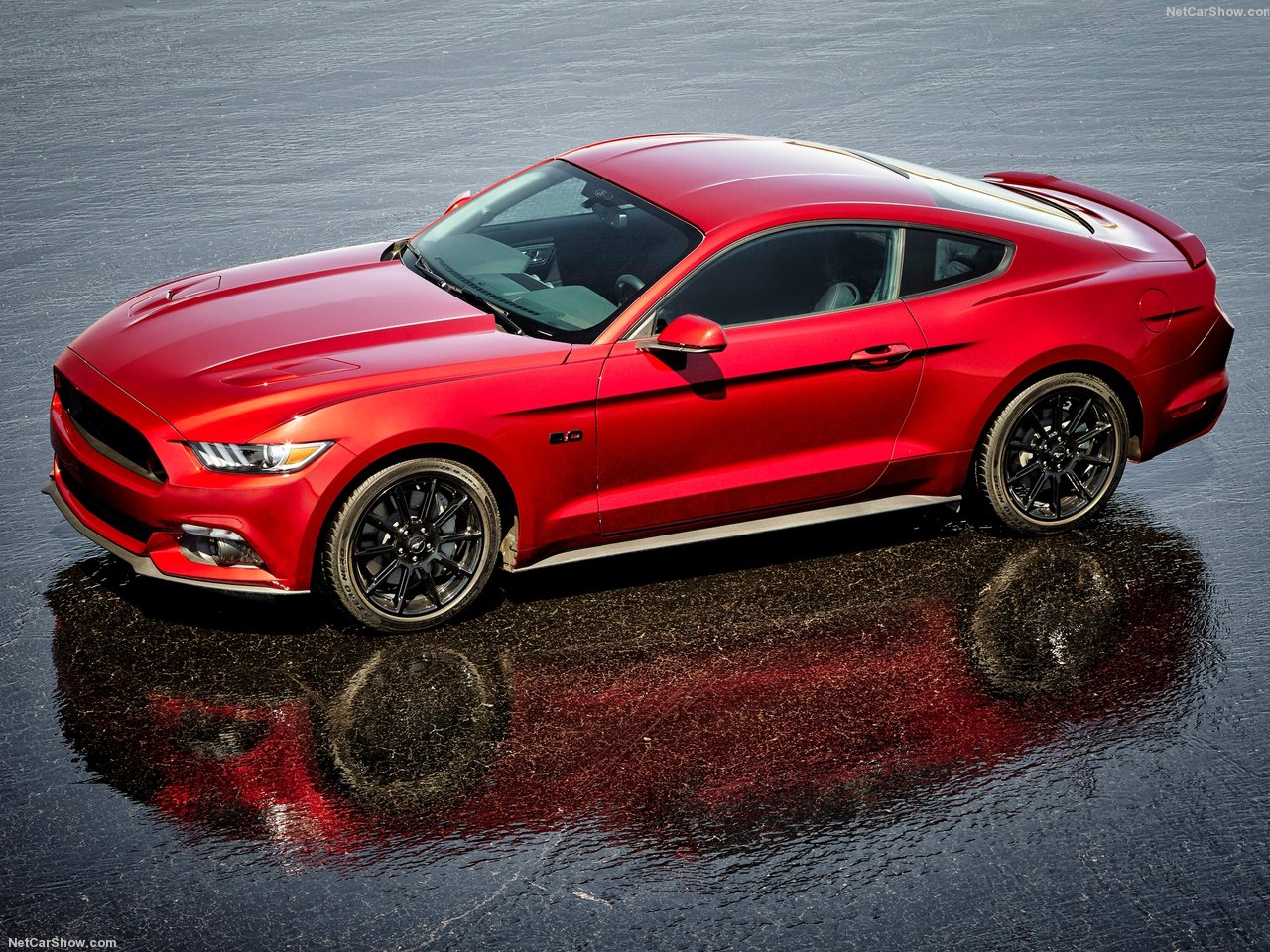 Ford-Mustang-2016-1280-02.jpg A red Ford Mustang driving on a track.