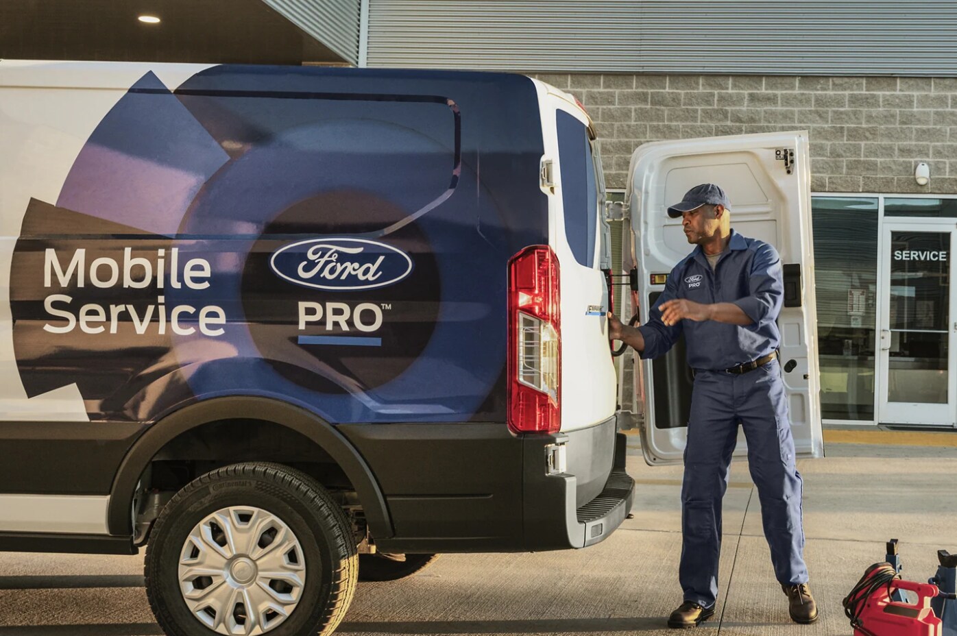 2023-ford-transit-7.PNG A man opens the back door of a 2023 Ford Transit