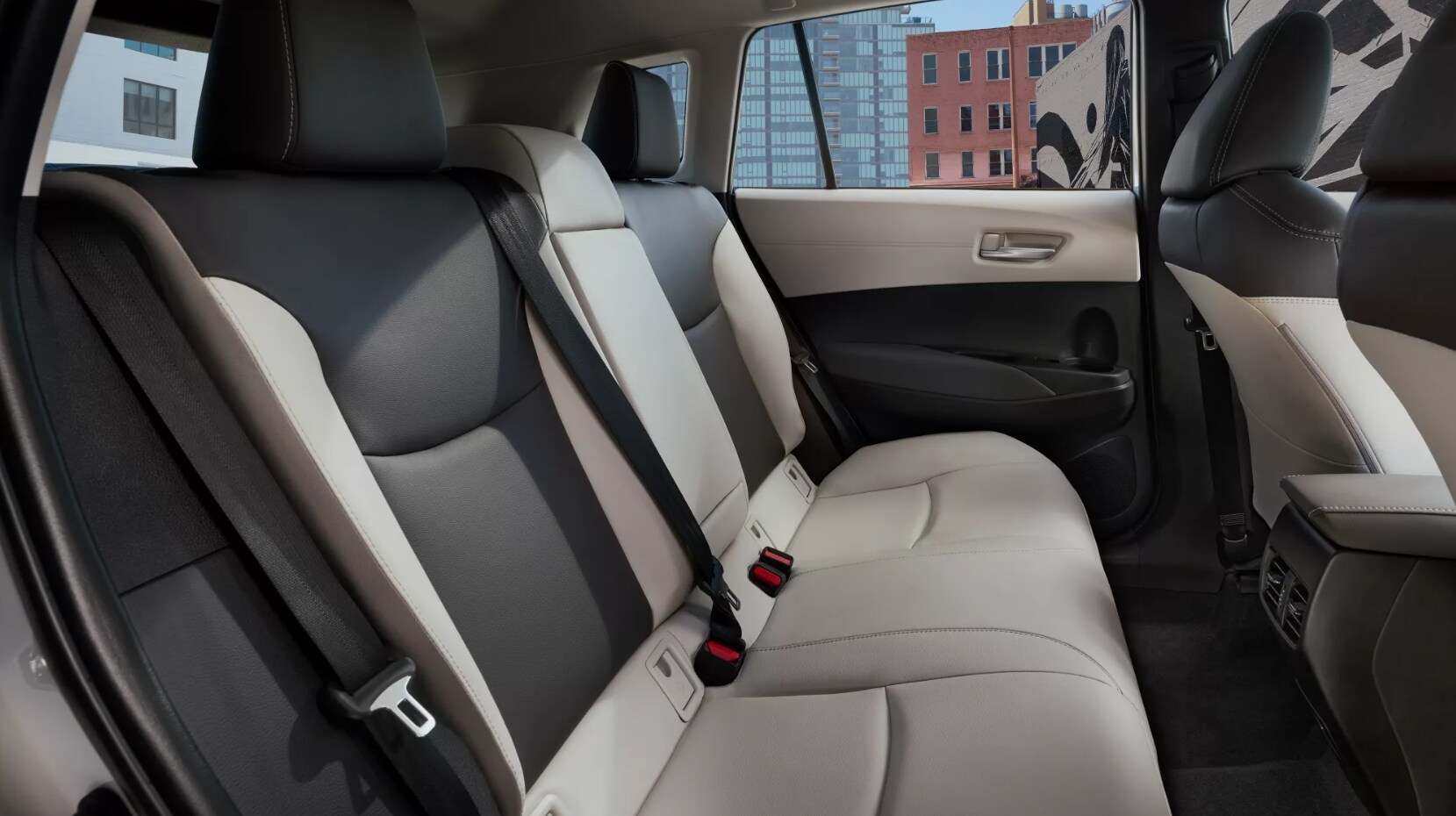 2022-Toyota-Corolla-Cross-5.PNG A view of the backseat of a two-toned dark dray and off white upholstered 2022 Toyota Corolla Cross