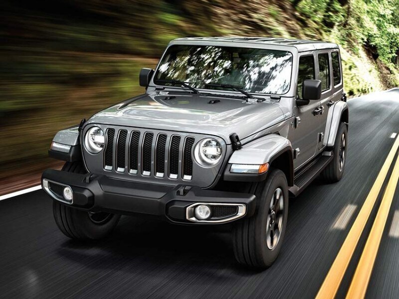 2019 Jeep Wrangler driving down a forest hillside road