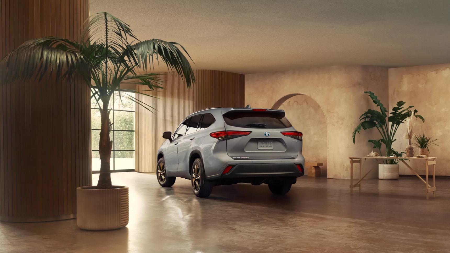 2022-Toyota-Highlander-3.PNG A view of the hatch/rear of a 2022 silver Toyota Highlander parked in an art studio