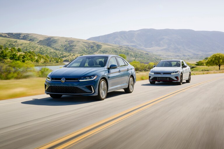 Two cars driving on a road.