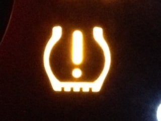 What looks like hazardous material symbol is actually a tire pressure warning. 