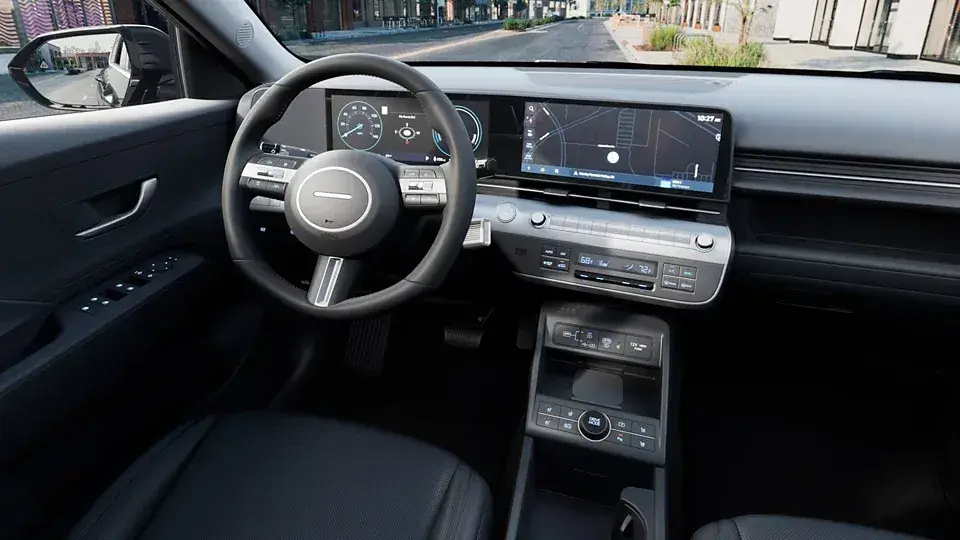 Hyundai Kona Electric dashboard with twin 12.3-inch screens seen from the driver's door
