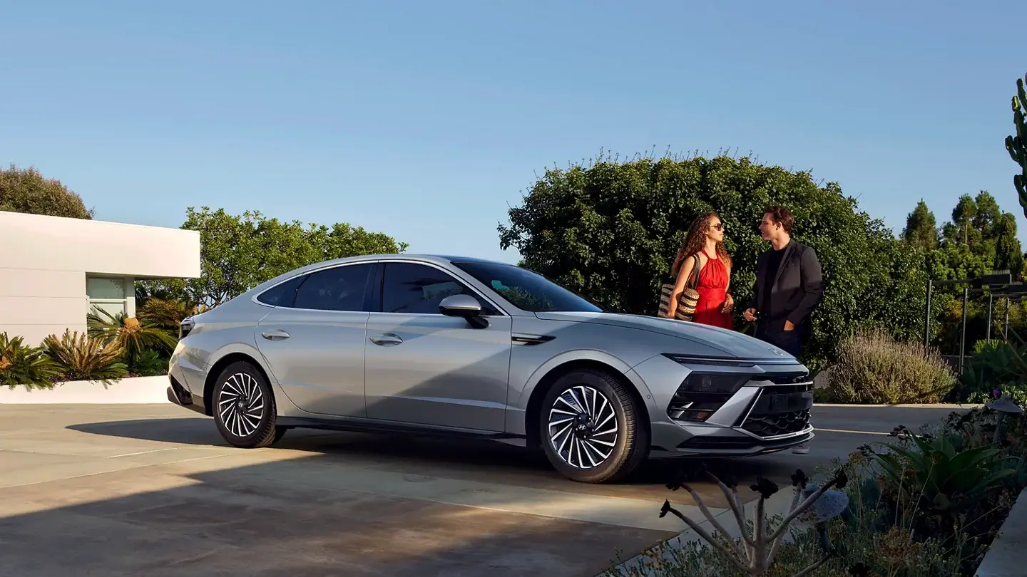Passenger side profile of the Hyundai Sonata Hybrid showing the fastback roofline