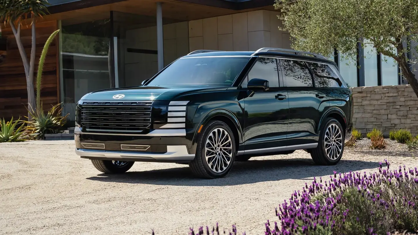 Front three-quarter view of a Hyundai Palisade showing the grille, hood line and front wheel