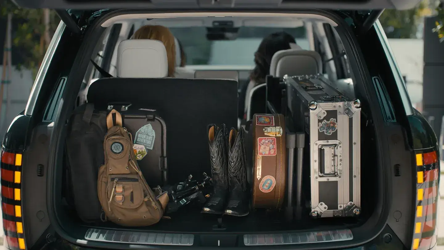 Open cargo area of a Hyundai Palisade with the third row folded down, showing the flat load floor