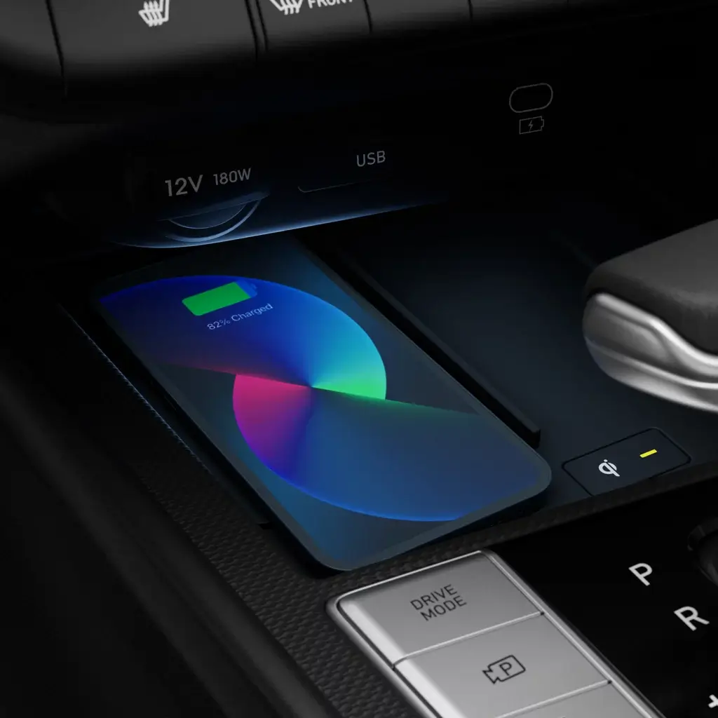 Wireless device charging pad in a Hyundai center console with a smartphone placed on it
