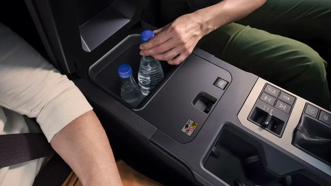 Center armrest storage compartment inside the 2027 Toyota Land Cruiser