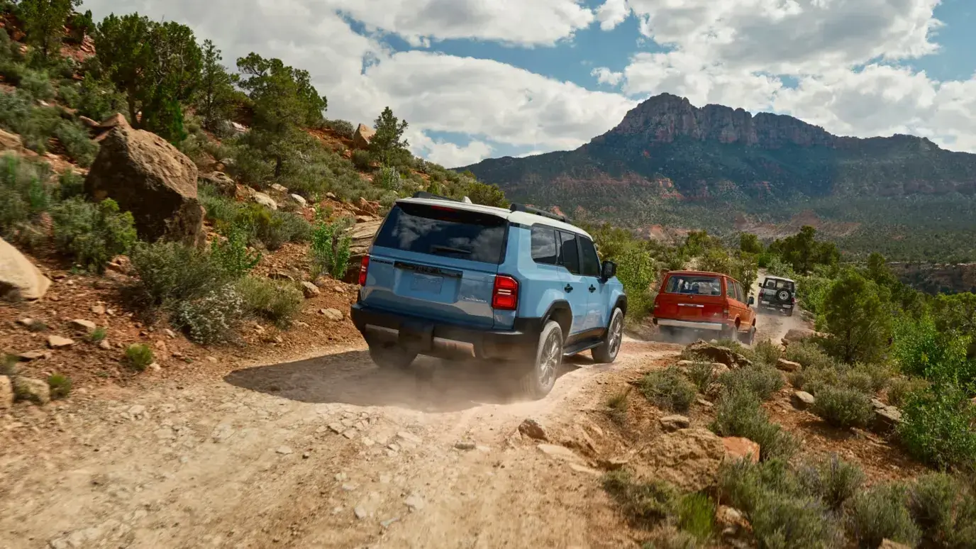 2027 Toyota Land Cruiser photographed off road from the rear three-quarter angle