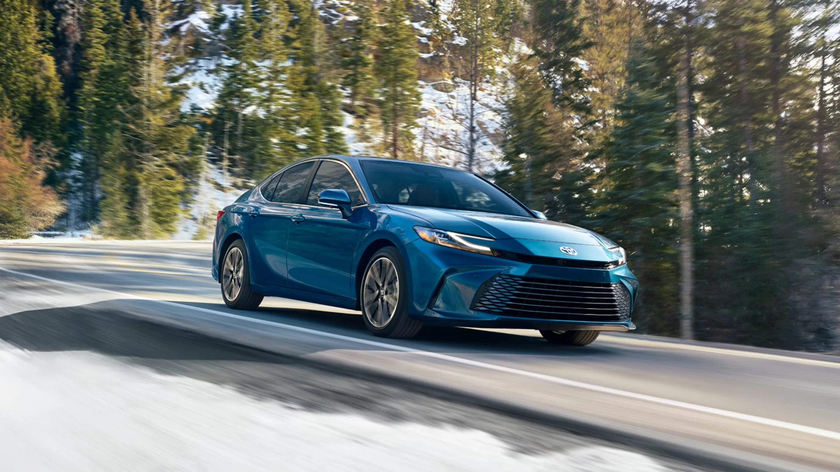Toyota Camry photographed from the front three-quarter angle in a winter setting