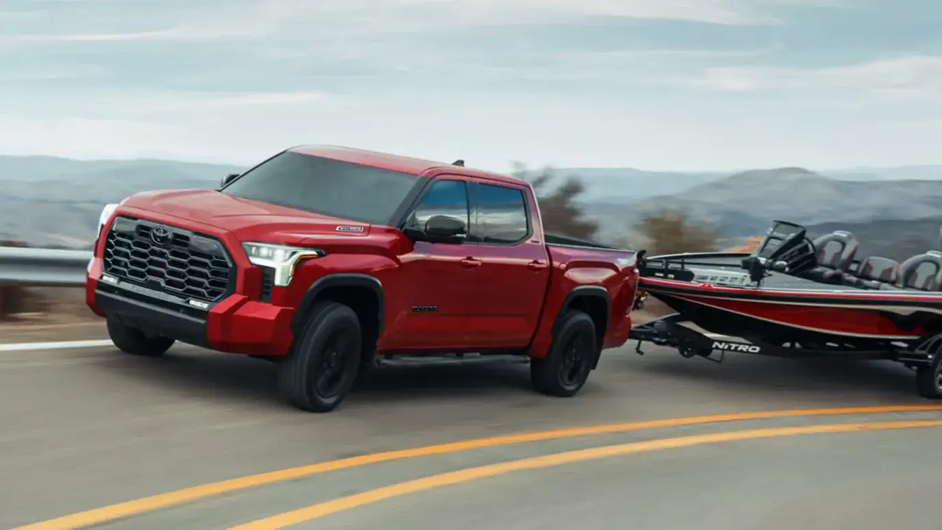 2027 Toyota Tundra i-FORCE MAX towing a trailer to show its towing capability