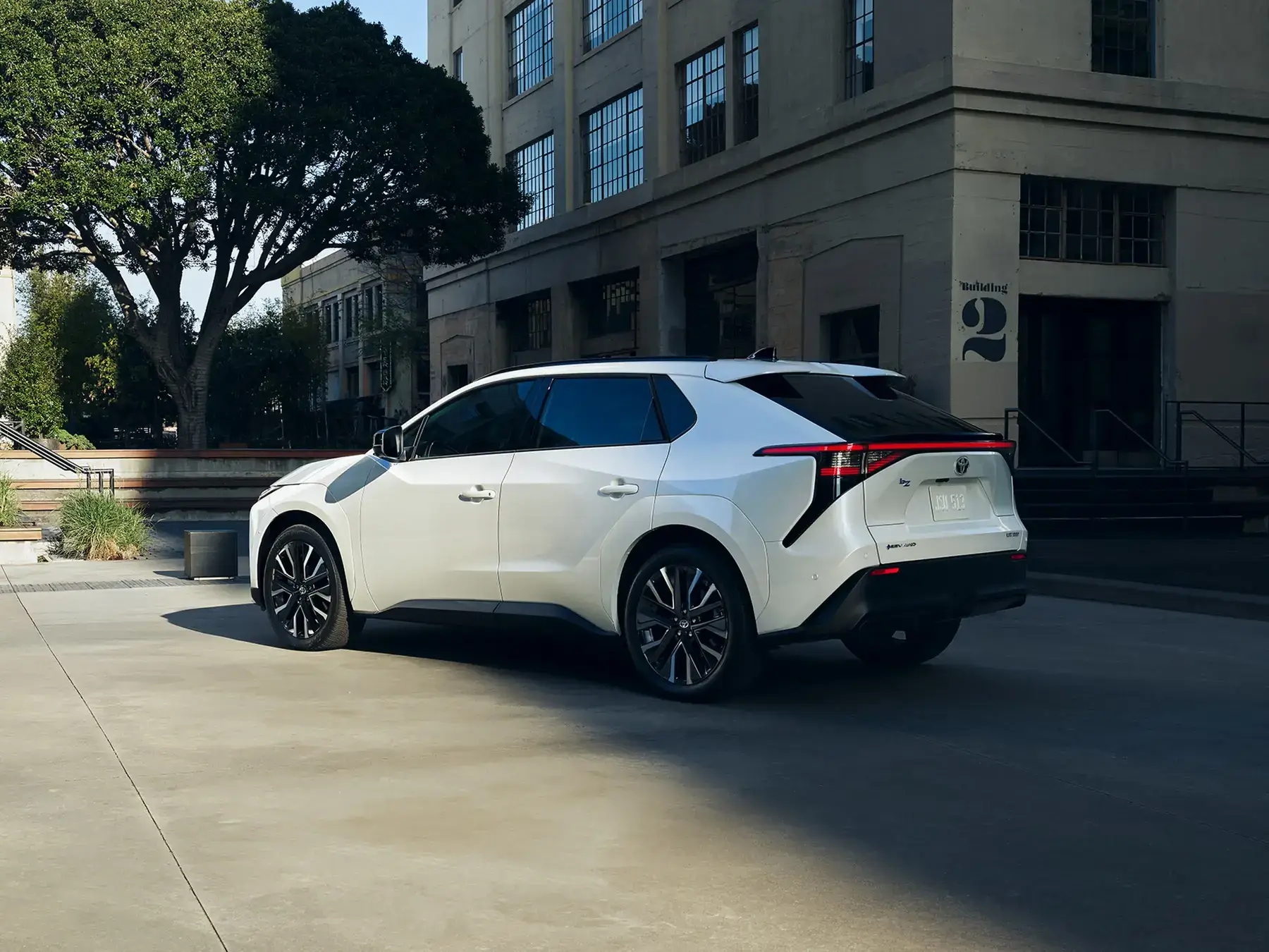 Driver-side profile of the Toyota bZ electric SUV showing alloy wheels and roofline