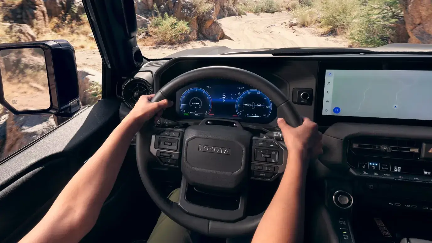 Steering wheel and dashboard of the 2027 Toyota Land Cruiser with digital gauge cluster