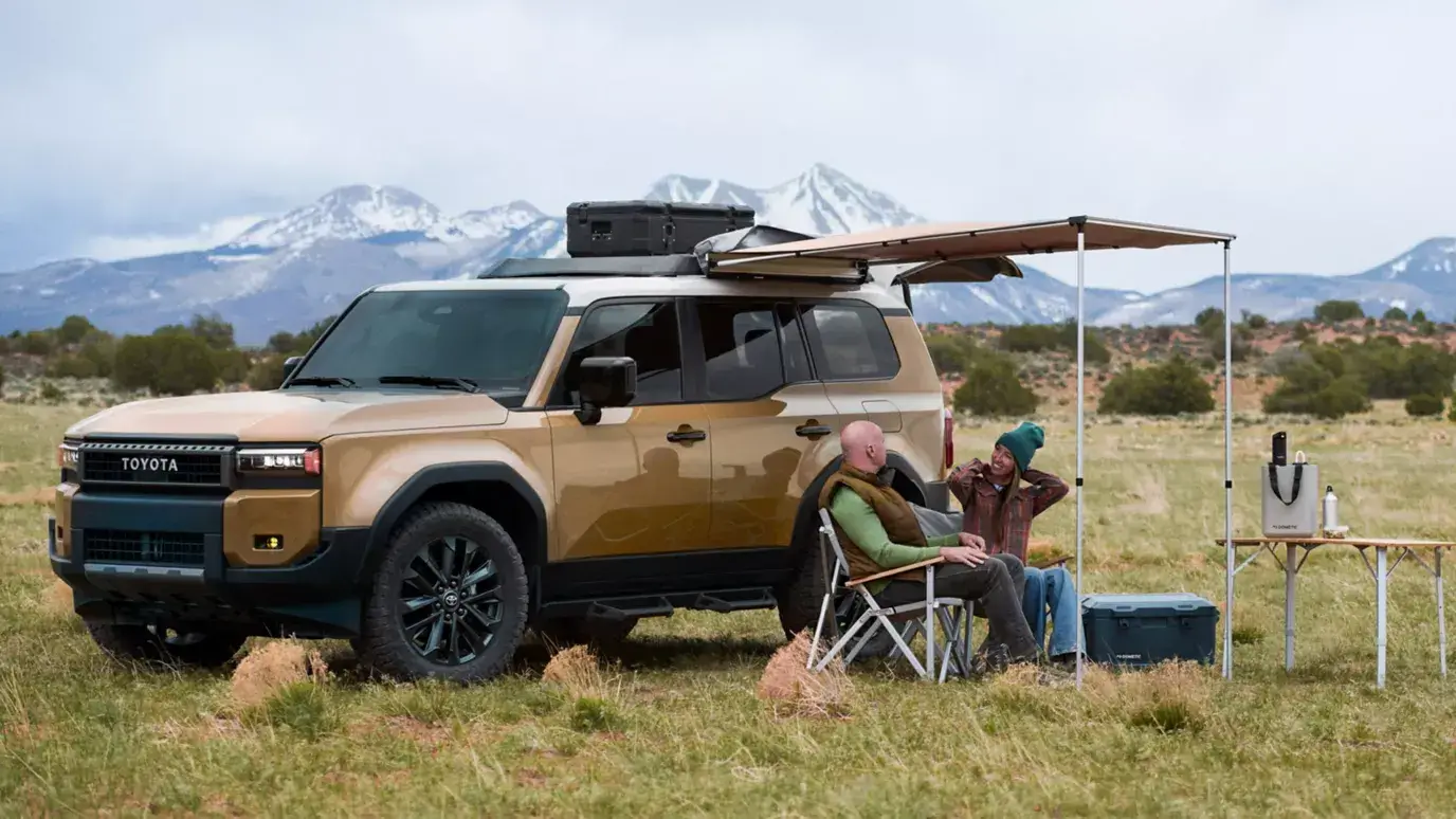 Toyota Land Cruiser parked outdoors loaded for an active weekend trip