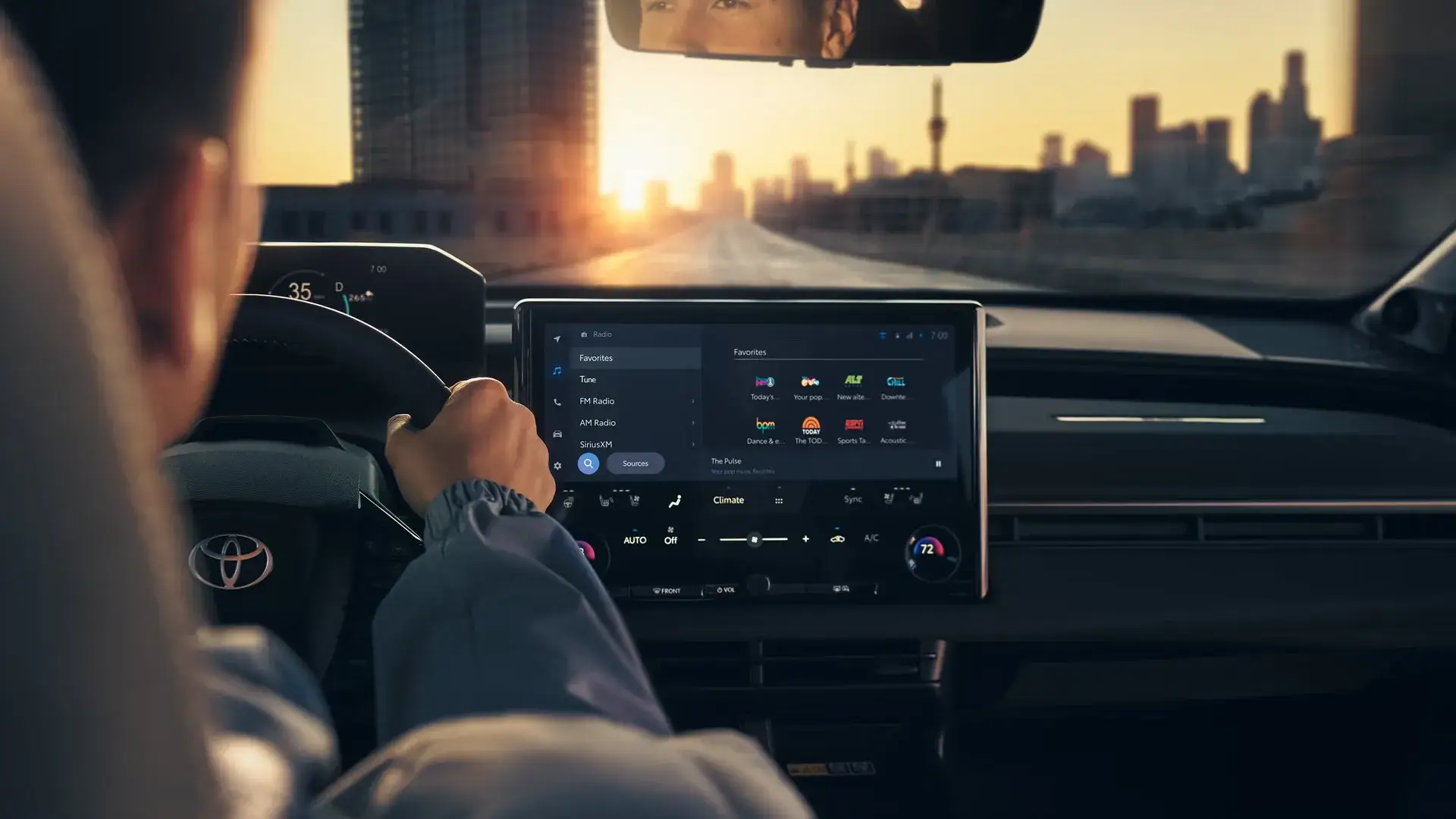 2027 Toyota bZ interior showing the 14-inch touchscreen and driver display while driving