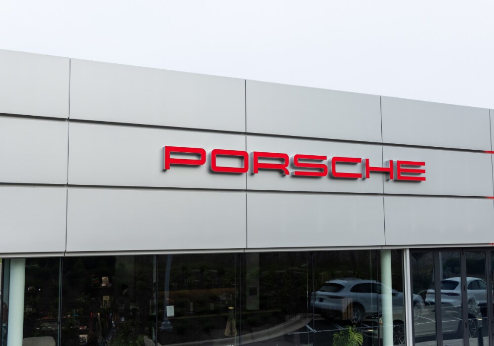 porsche-dealership-near-hendersonville.png Exterior of Porsche Asheville dealership showing the Porsche logo affixed to the front of the building in red lettering
