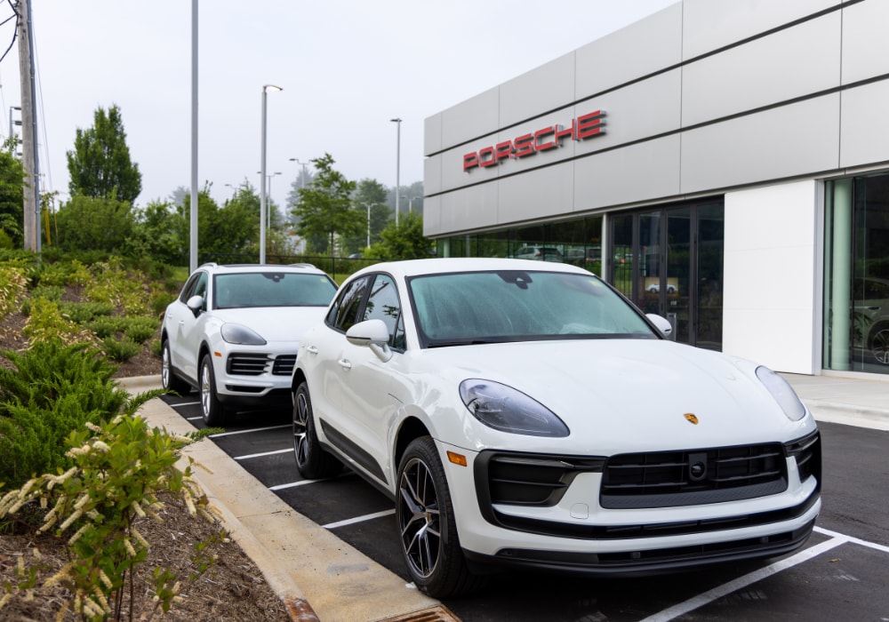 porsche-dealership-asheville-nc.png Two used Porsche cars parked outside a Porsche dealership located in Asheville, NC