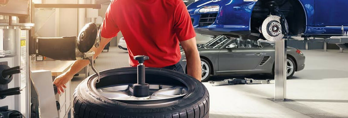 Porsche Tire Rotation Porsche technician performing a tire rotation