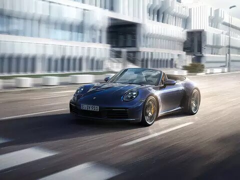 Porsche 911 driving down the road