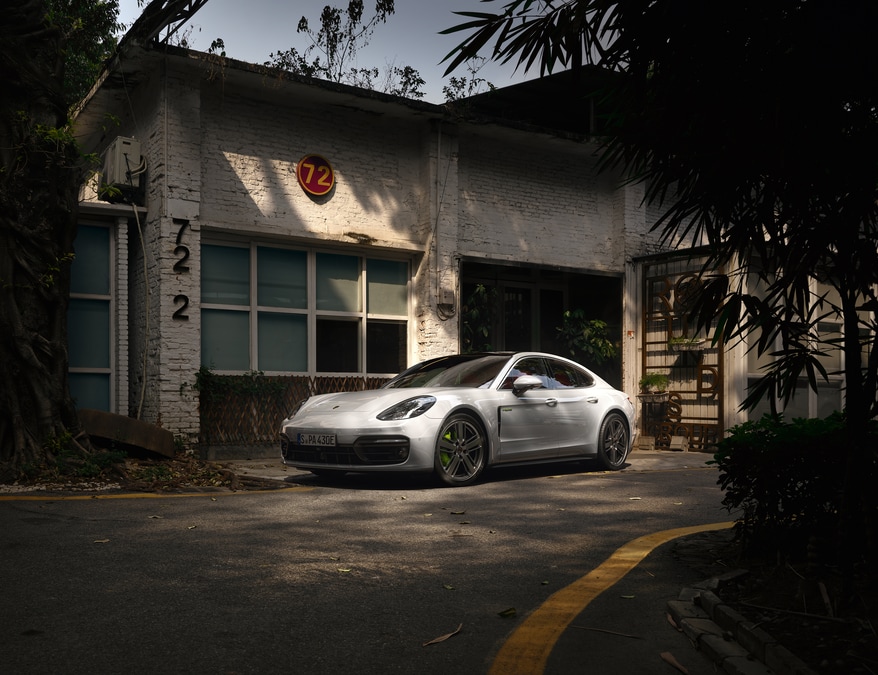 2025-Porsche-Panamera-4SEHybrid-Hatchback-L03.png porsche panamera e-hybrid parked in front of an old garage