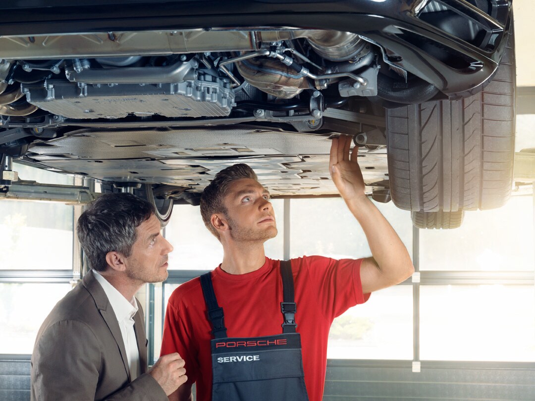 Porsche Towson is a Luxury Car Dealership near Lutherville-Timonium MD | Porsche Service Center checking underneath of car