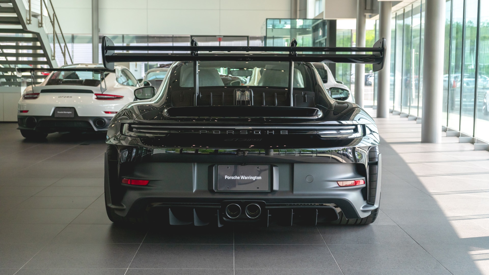 2023-Porsche-992-GT3-RS-Exterior-Back.jpg Back view of black GT3 RS in Porsche Warrington showroom.