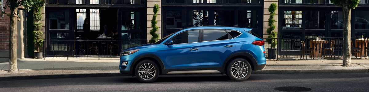 2019-Hyundai-Tucson-Sport-SUV-L01 (1).jpg New Hyundai Tucson outside a storefront