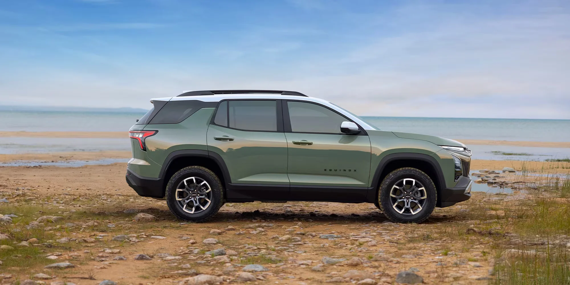 2026 Chevy Equinox ACTIV side profile at the beach with all-terrain tires