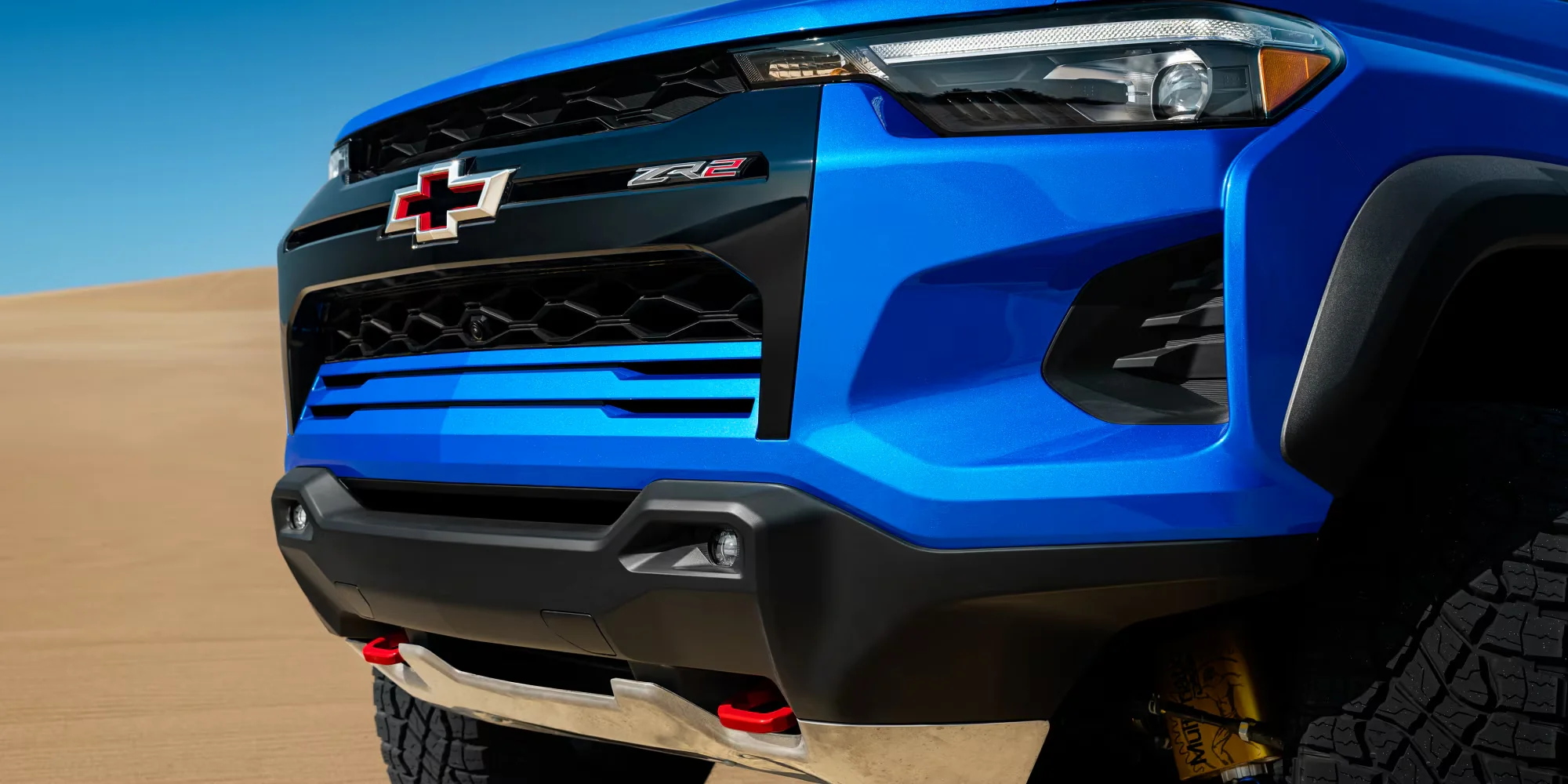 2026 Chevy Colorado ZR2 front grille close-up in sand, showing the off-road front end