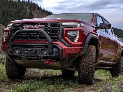 2025 GMC Canyon parked on a hill covered in mud