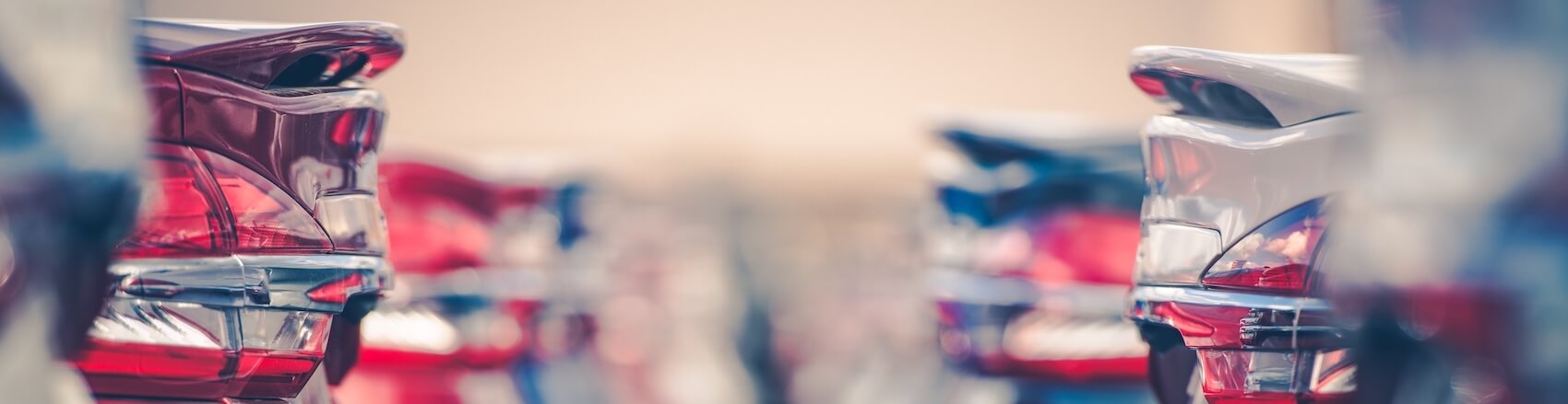 A close up of a bunch of used car's bumpers parked on our used car lot near Miami Beach FL.
