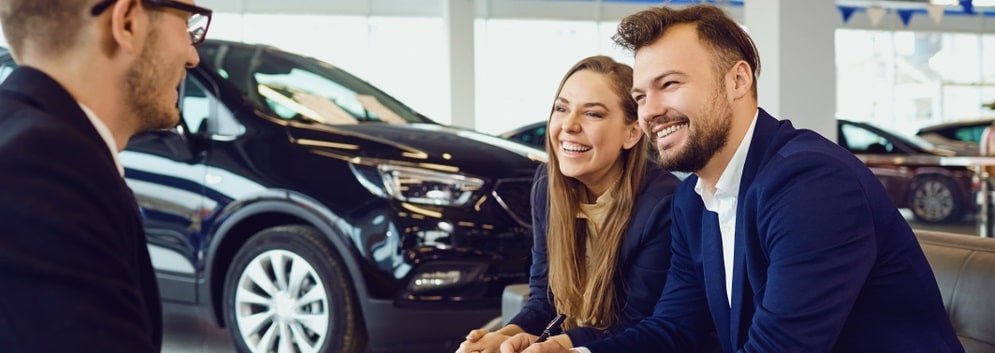 Dealership staff helping someone shopping for a used car at our North Miami FL used car dealer.