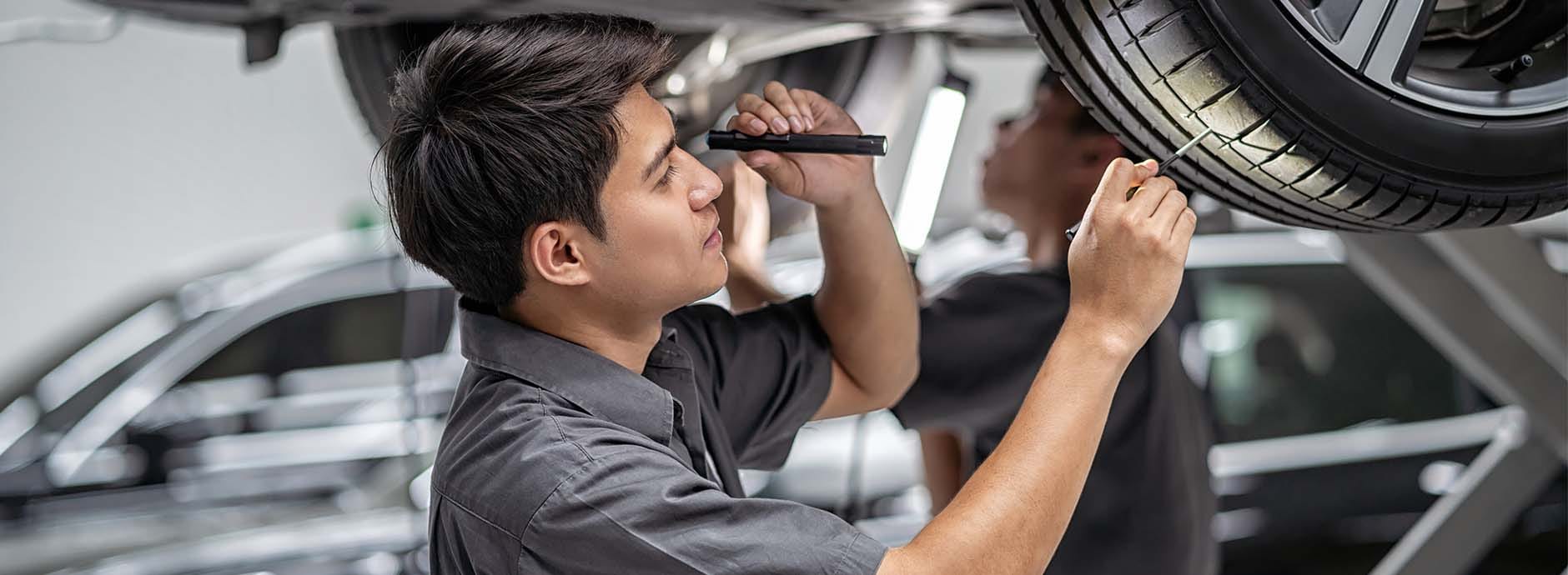 service_tech_checking_tires.jpg
